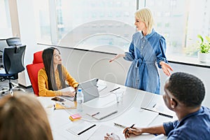 businesswoman talking to coworkers sharing business ideas