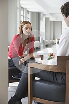 Businesswoman Talking To Cropped Man In Office