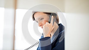 Businesswoman Talking to Someone Using Telephone