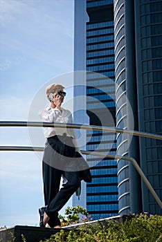 Businesswoman walks next to office building