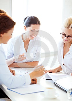 Businesswoman with team on meeting in office