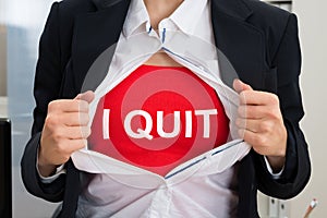 Businesswoman Tearing Off Shirt With I Quit Sign