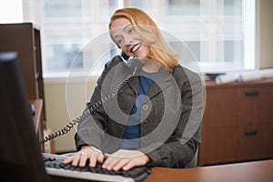 Businesswoman on telephone and computer