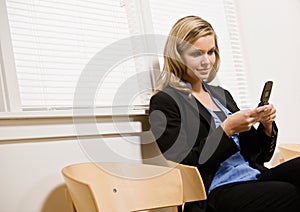 Businesswoman text messaging on cell phone