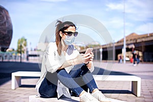 Businesswoman text messaging while on the street during pandemic