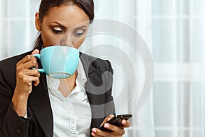 Businesswoman texting on mobile phone