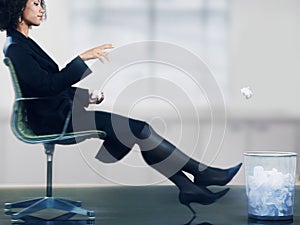 Businesswoman Throwing Paper Ball Into Dustbin