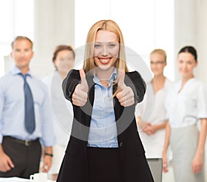 Businesswoman with thumbs up in office