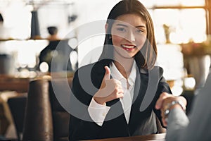 Businesswoman thumbs up and shake hands and accept the terms of business