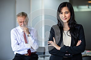 Businesswoman thumbs up and stands smiling confidently and laughing happy in the conference room