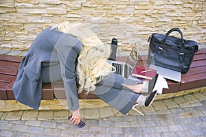 Businesswoman is tired. Woman lying on bench