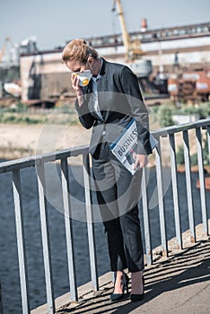 businesswoman touching protective mask on bridge air