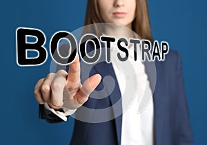 Businesswoman touching virtual screen with word BOOTSTRAP against background, focus on hand