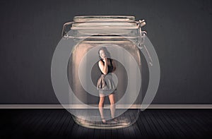 Businesswoman trapped into a glass jar concept