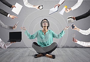 Businesswoman tries to keep calm with yoga due to stress and overwork at wok photo