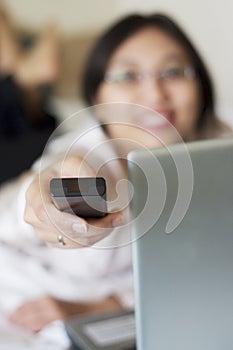 Businesswoman with TV remote control