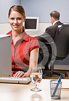 Businesswoman typing on computer at desk