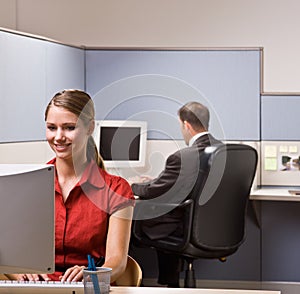 Businesswoman typing on computer at desk