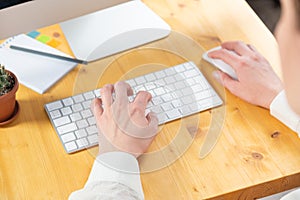 Businesswoman typing on computer keyboard at workplace Woman working in home office hand keyboard