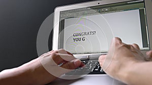 Businesswoman typing congrats you got the job on the keyboard and the words appear on computer screen