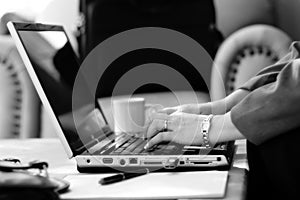 Businesswoman Typing in Hotel Atrium (BW)