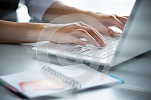 Businesswoman typing on a laptop