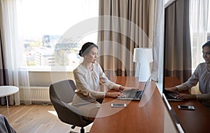 Businesswoman typing on laptop at hotel room