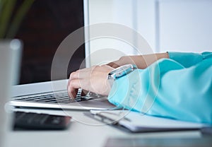 Businesswoman typing on laptop at office workplace Woman working in home office hand keyboard