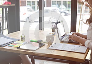 Businesswoman typing on laptop at workplace. Woman working in ho