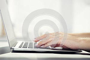 Woman typing on laptop at workplace Woman working in home office hand keyboard