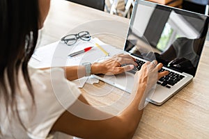Businesswoman typing on laptop at workplace Woman working in home office hand keyboard
