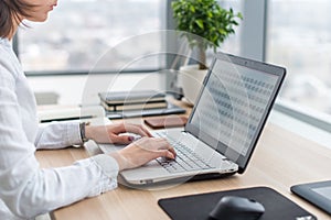 Businesswoman typing on laptop at workplace Woman working in office hand keyboard