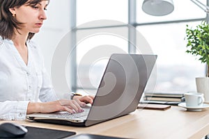 Businesswoman typing on laptop at workplace Woman working in office hand keyboard