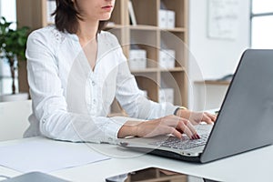 Businesswoman typing on laptop at workplace Woman working in office hand keyboard