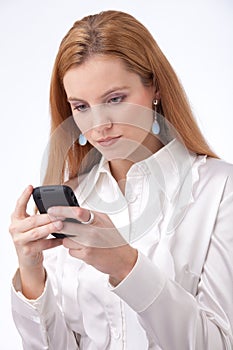 Businesswoman typing on smartphone