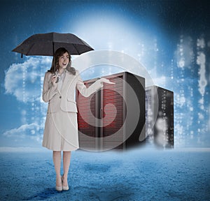 Businesswoman with umbrella in front of red servers