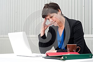 Businesswoman under stress, fatigue, and headache
