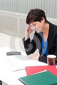 Businesswoman under stress, fatigue, and headache