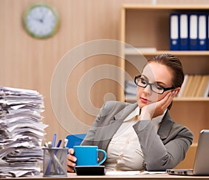 Businesswoman under stress from too much work in the office
