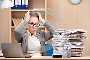The businesswoman under stress from too much work in the office