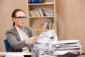 The businesswoman under stress from too much work in the office