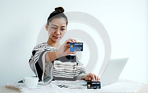 Businesswoman use credit card to online shopping from home with laptop, payment e-commerce, internet banking, spending money for