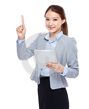 Businesswoman use of tableta and finger point up photo