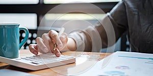 A businesswoman uses a laptop to calculate investment results. And making financial reports on the desk Business finance