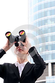 Businesswoman using binoculars