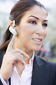 Businesswoman using bluetooth earpiece