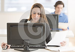 Businesswoman Using Desktop Pc At Desk