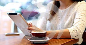 Businesswoman using digital tablet in cafÃ©