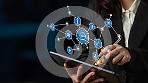 Businesswoman Using Digital Tablet with Network Connections and Icons Representing Technology, Communication, and Data