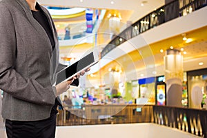 Businesswoman using digital tablet in the shopping mall.